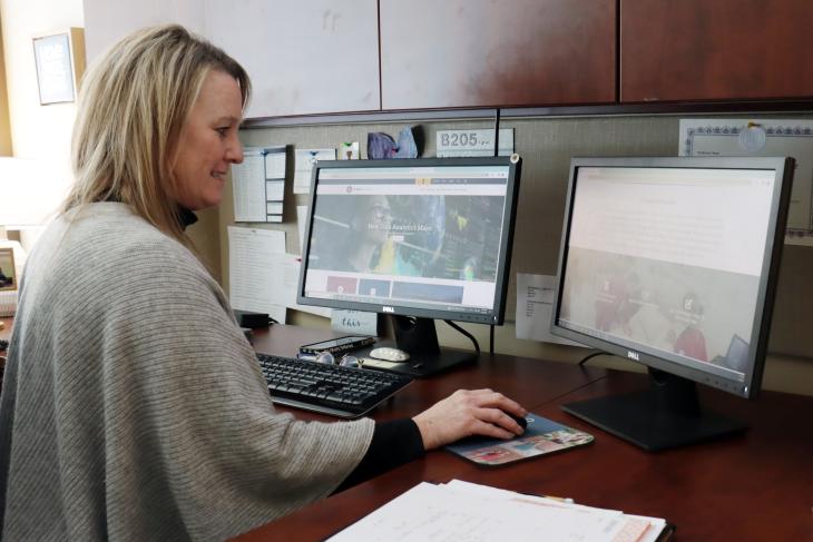 Jenny Hedrick-Erickson at her desk at Viterbo University